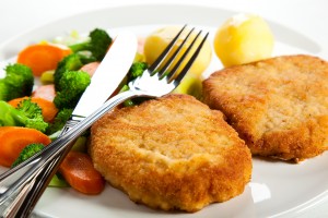 Fried pork chop with boiled potatoes and vegetables