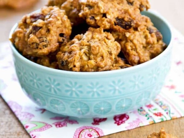 Crispy Raisin Cookies in a blue bowl on a wood table