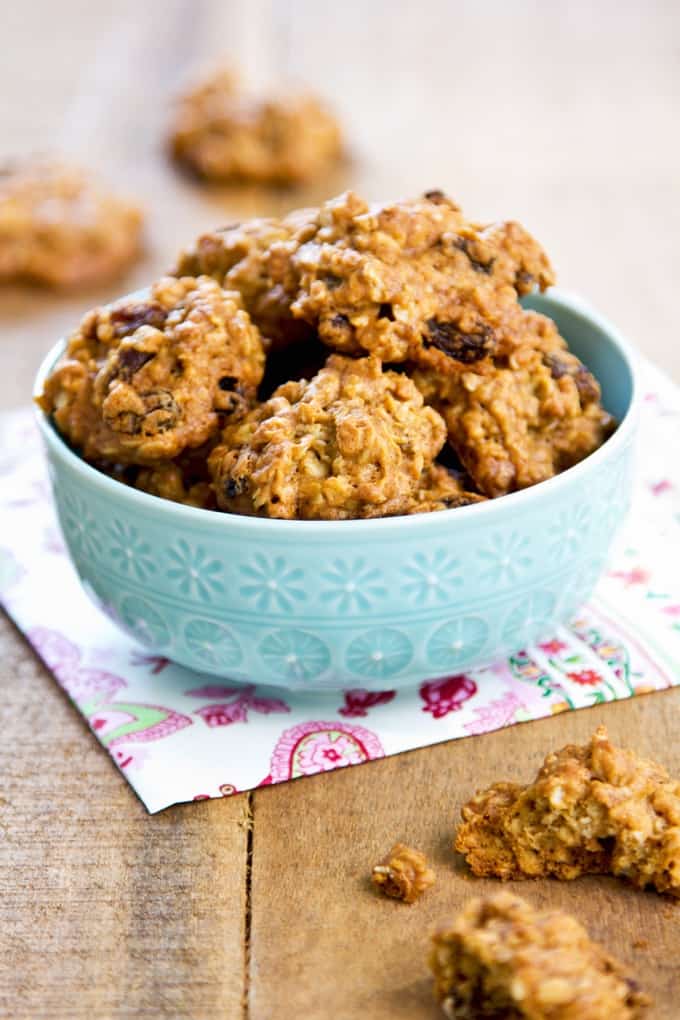 Crispy Raisin Cookies in a blue bowl on a wood table
