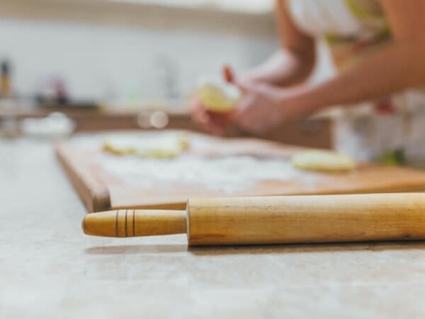 Baking class or recipe concept on dark background, sprinkled wheat flour with free text copy space. Baking preparation, top view on wooden board or table. Cooking dough or pastry.