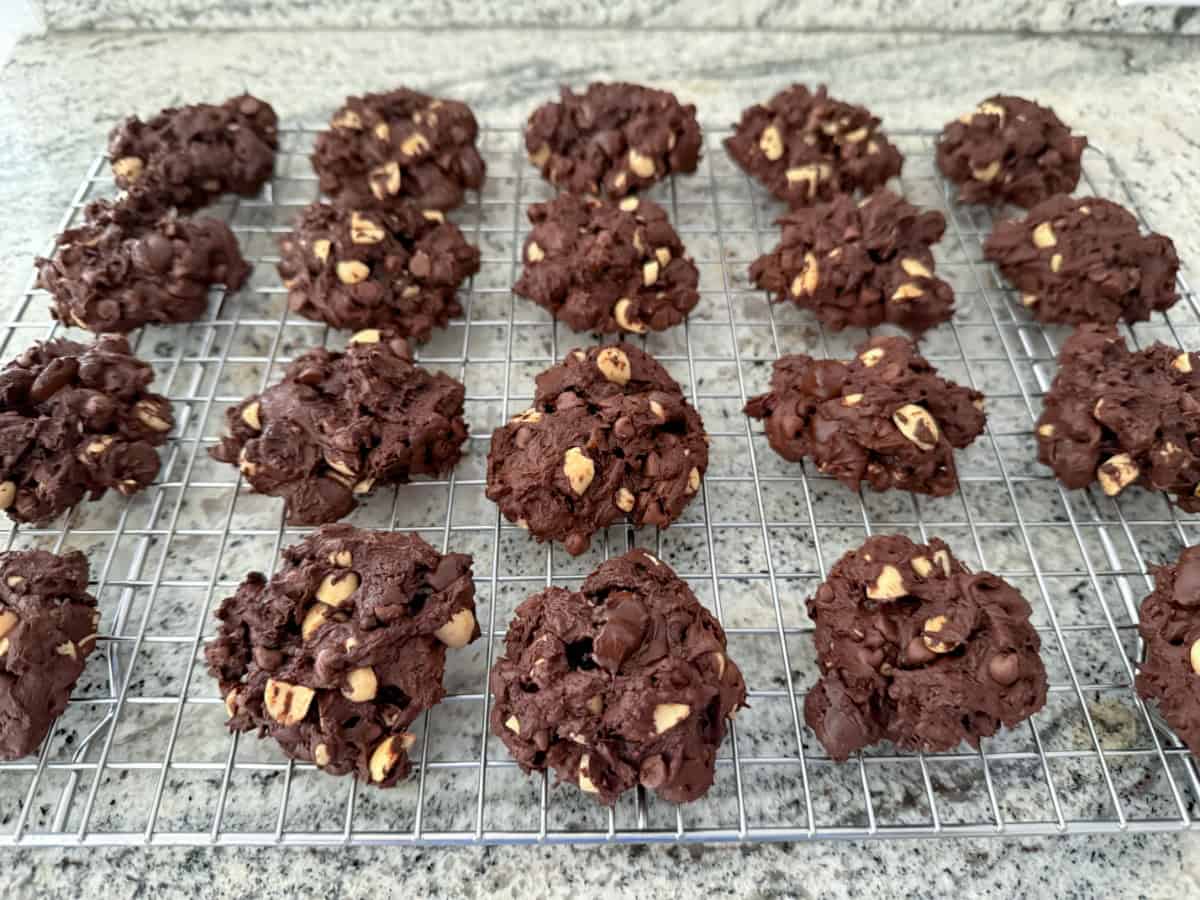 Chunky chocolate cookies cooling on wire rack.