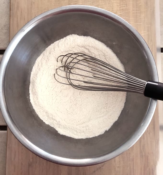 Whisking flour, baking powder, salt and sugar in mixing bowl