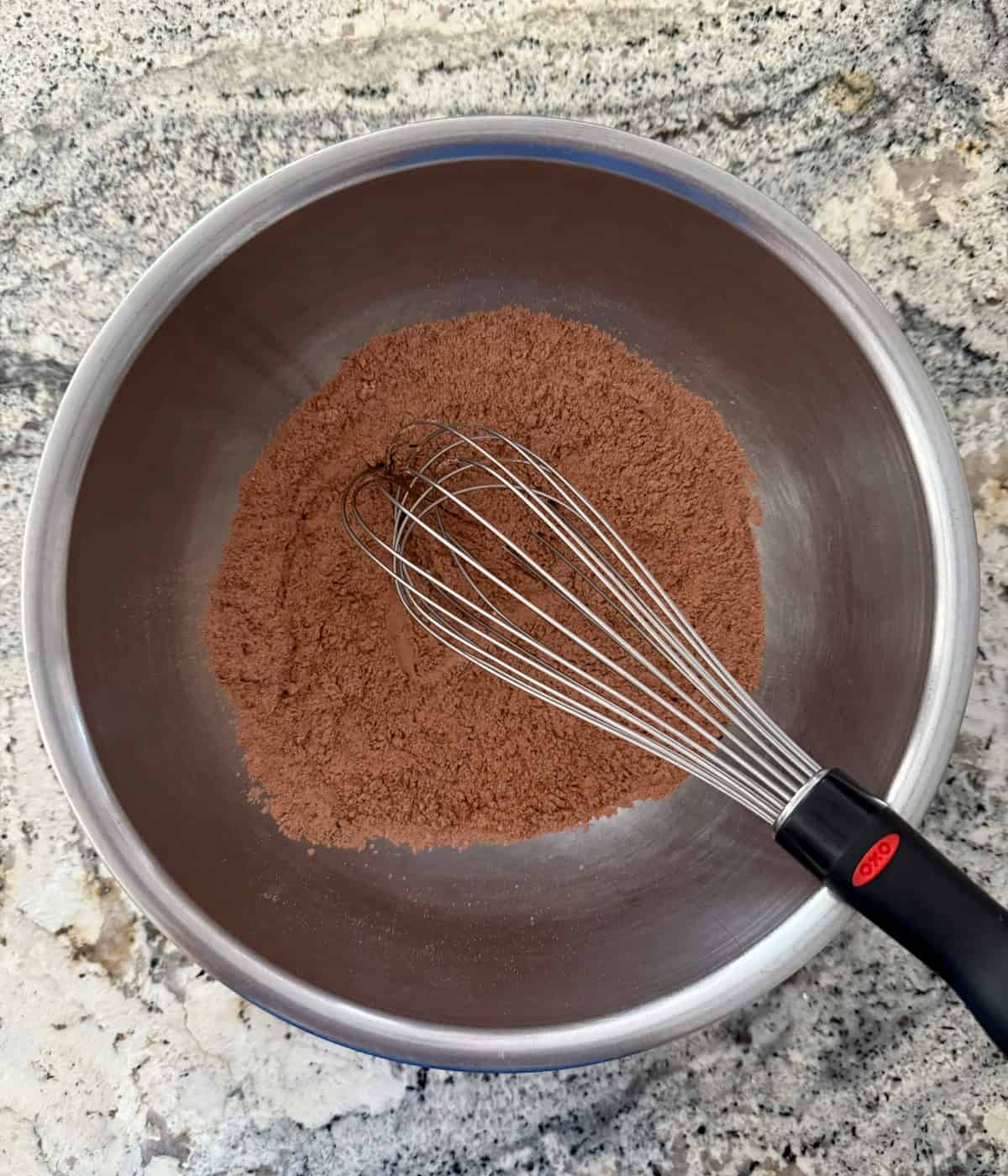 Whisking flour, cocoa powder, salt and baking powder in mixing bowl.