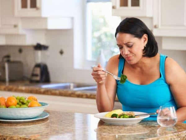 Woman in Kitchen Fed Up with Diet