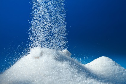 White sugar being poured into a small mound