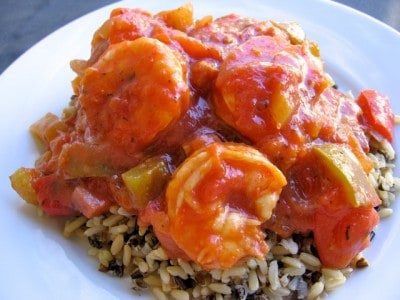 Easy Shrimp Creole over rice on white plate.