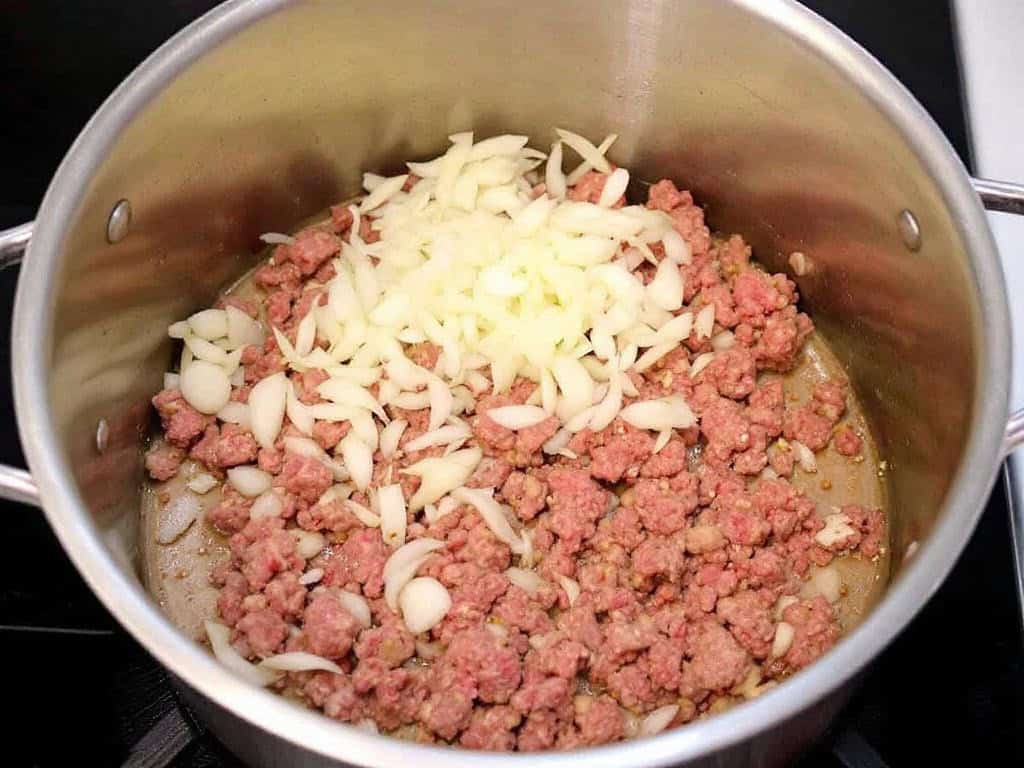 Browning ground beef and onion in a soup pot.