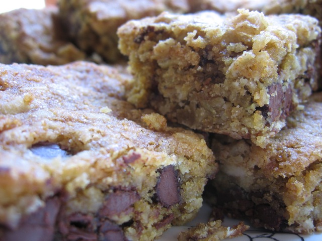 Stacked oatmeal chocolate chip cookie bars stacked on a plate close up