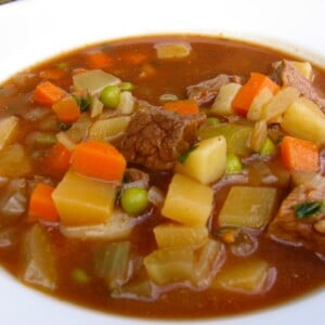 Close Up Hearty Beef & Vegetable Slow Cooker Soup in White Bowl