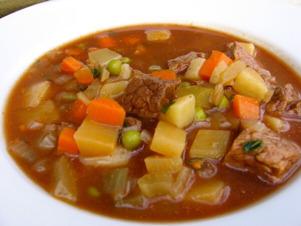 Close Up Hearty Beef & Vegetable Slow Cooker Soup in White Bowl