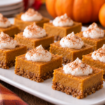 individual pumpkin pie bites decoratively arranged on white platter