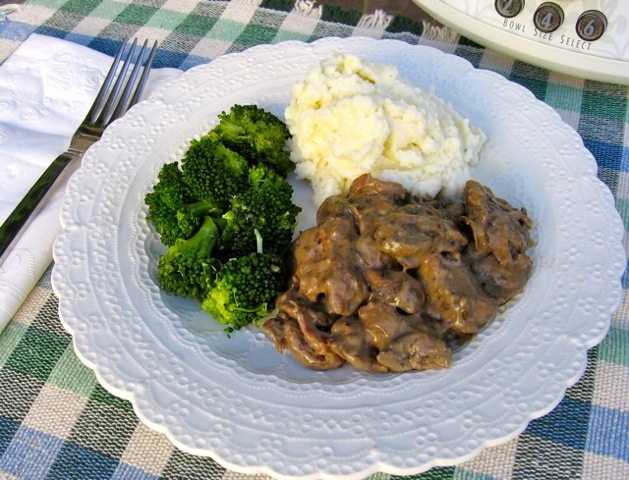 Beef and Mushrooms with Mashed Potatoes and Broccoli on white dinner plate.