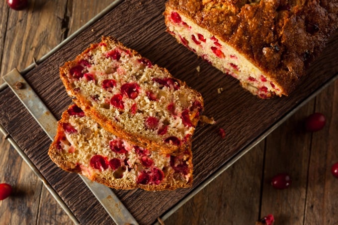 Slices of Cranberry Orange Oatmeal Bread on a wooden table