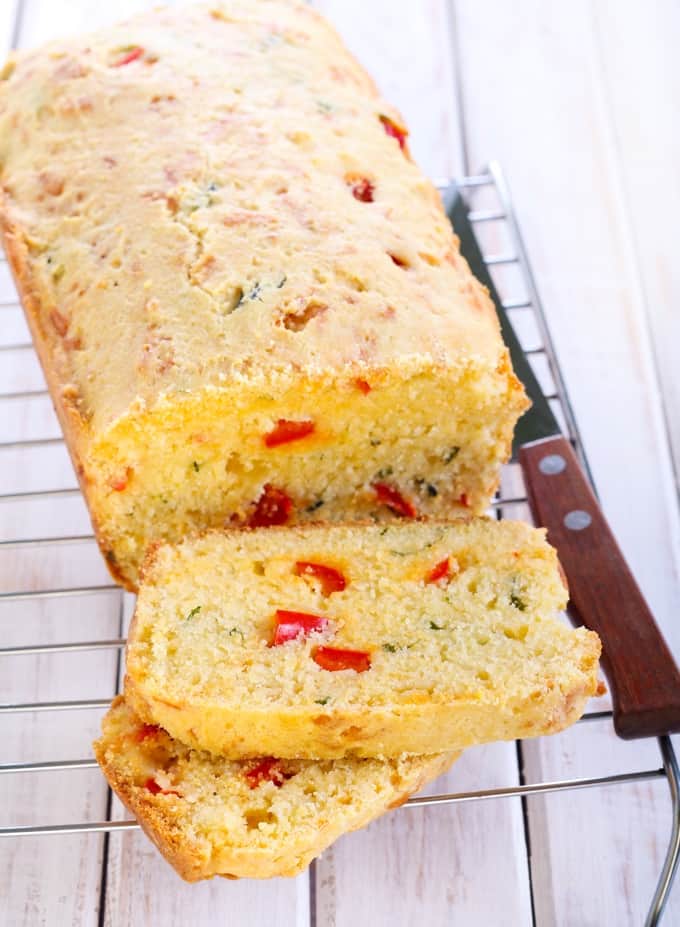 Slices of cornbread with cheese, red pepper and herbs