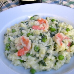 Shrimp Risotto with peas and asparagus in wide rimmed white bowl