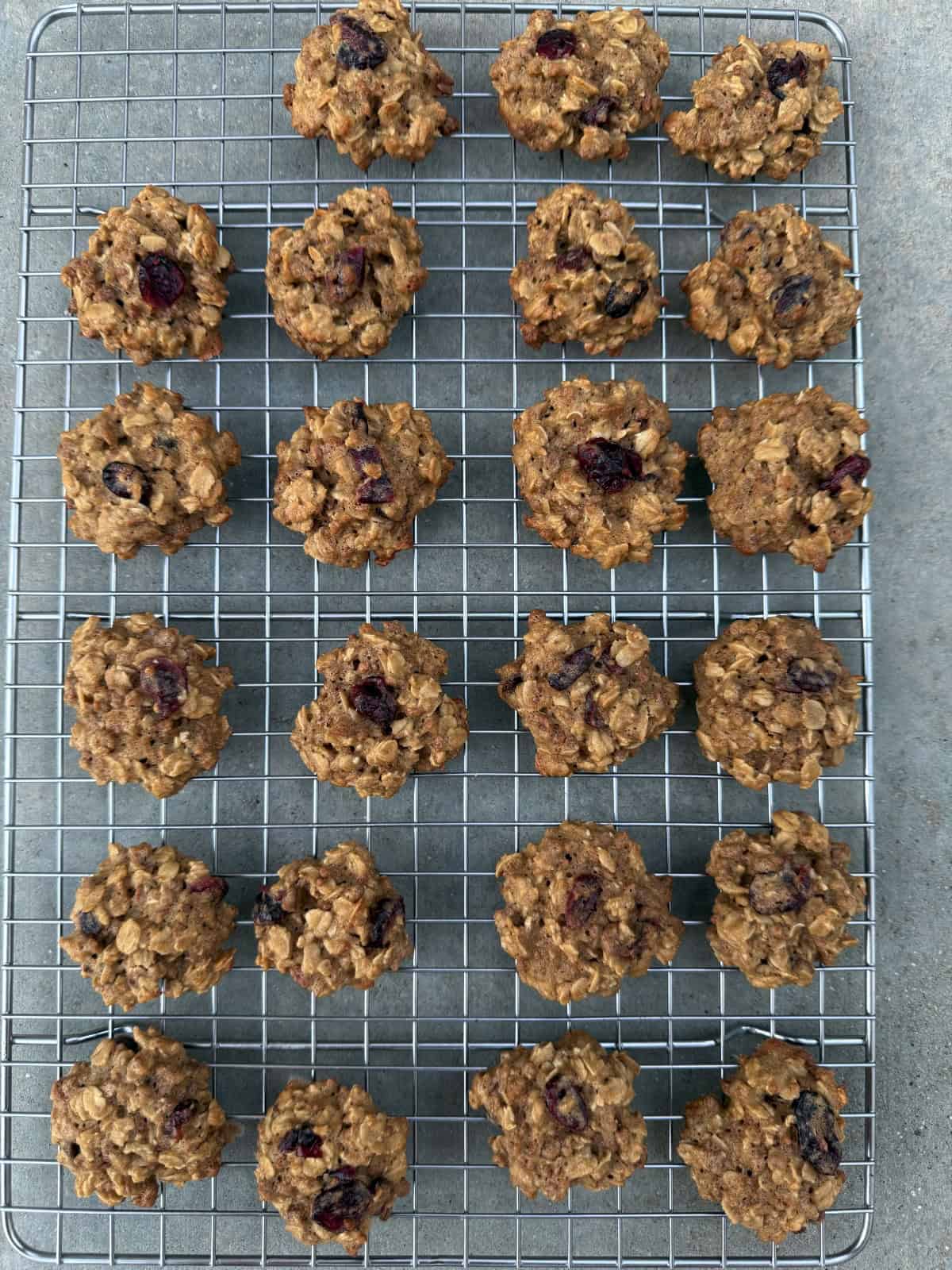 Grape Nuts Breakfast Cookies with dried cranberries cooling on wire rack.
