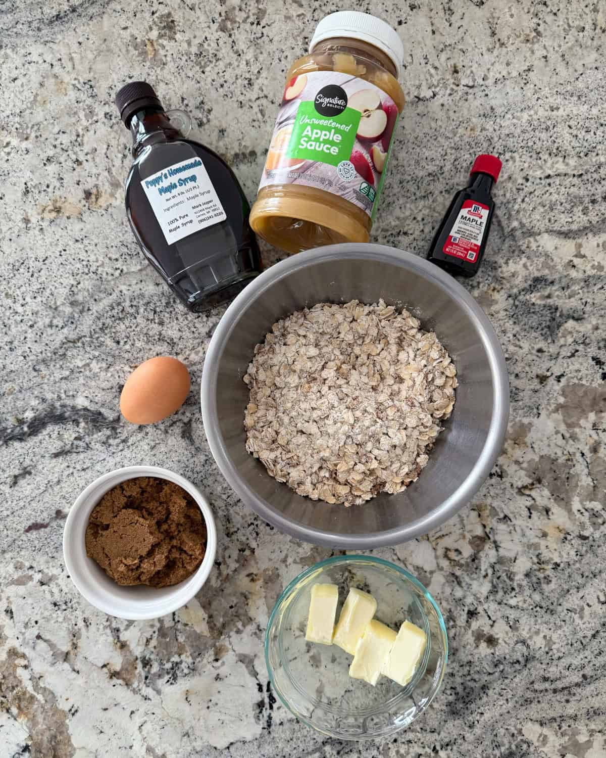 Ingredients including maple syrup, applesauce, maple extract, egg, brown sugar, rolled oats and butter.