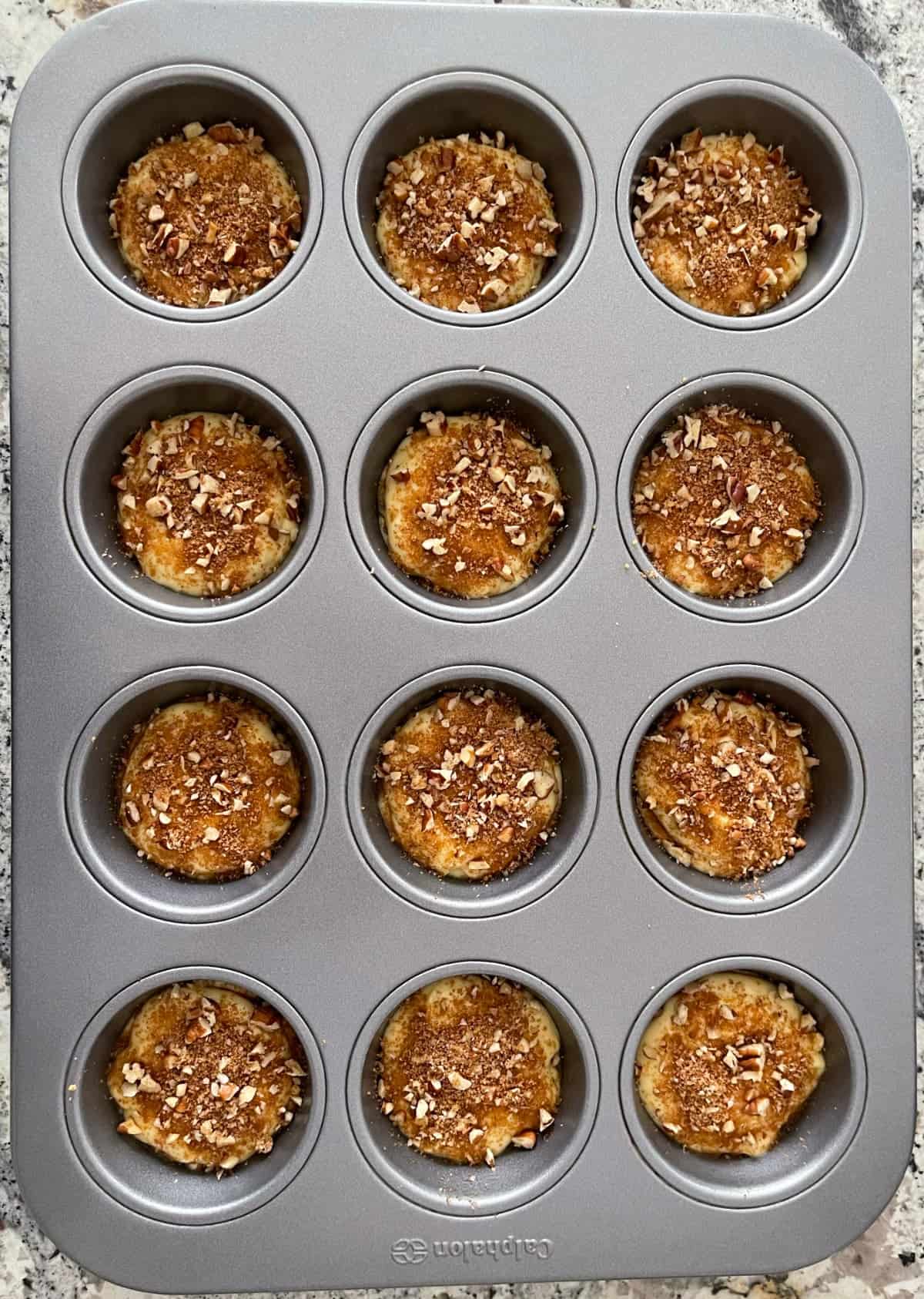 Unbaked cinnamon streusel muffins in 12-cup standard muffin pan.