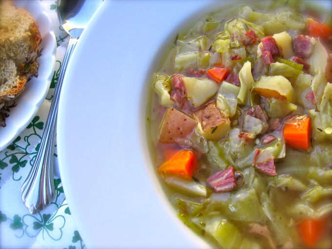 Skinny Leftover Corned Beef and Cabbage Soup in white wide rimmed soup plate