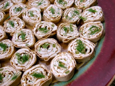 Skinny Smoked Salmon Pinwheels appetizers on a serving platter.
