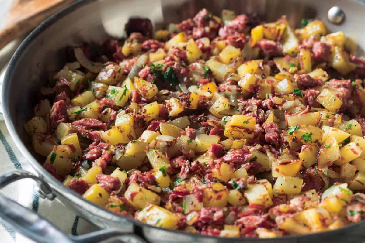 Cooking leftover corned beef hash in a skillet.