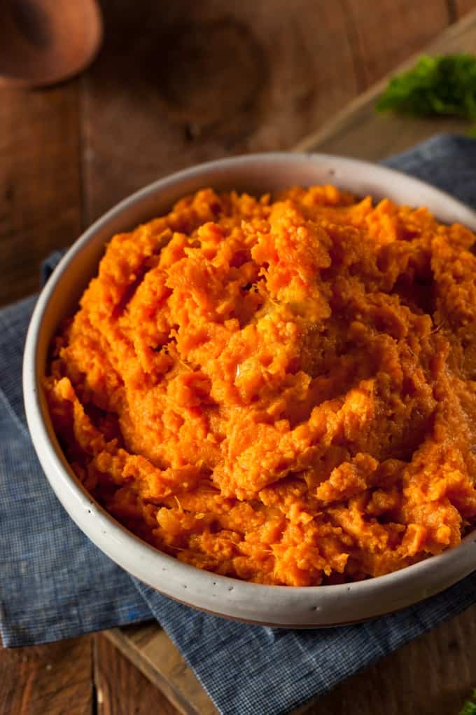 Mashed Sweet Potatoes in a brown ceramic serving bowl