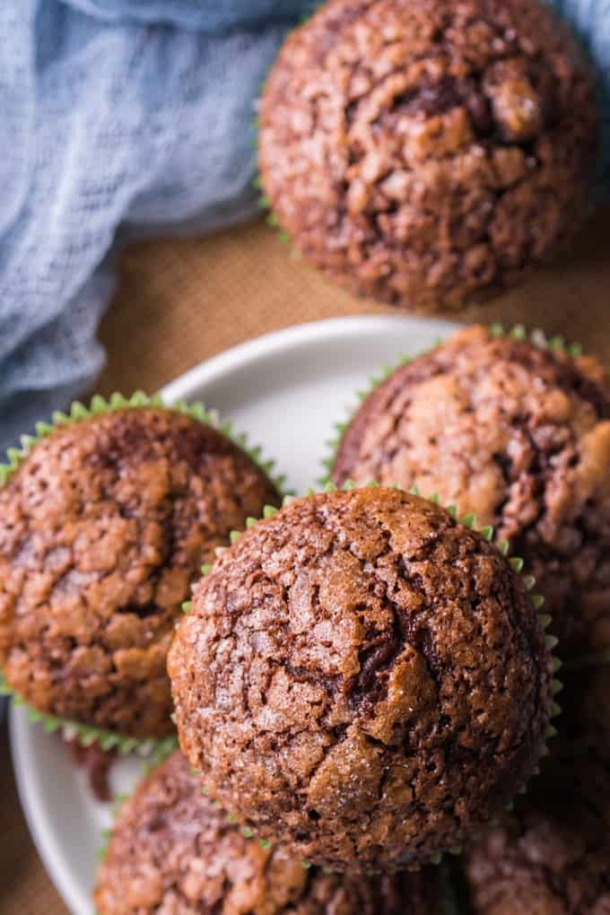 Chocolate Banana Muffins stacked on a white plate