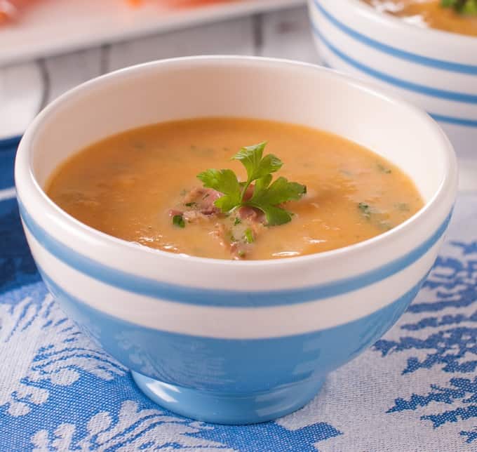 Curried Sweet Potato Soup with Coconut Milk in a blue and white striped bowl.