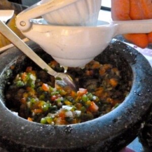 Adding fresh squeezed lime juice to salsa