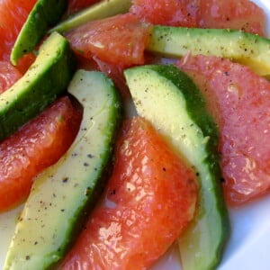 alternating avocado and pink grapefruit wedges spiraled on white plate