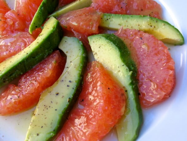 alternating avocado and pink grapefruit wedges spiraled on white plate