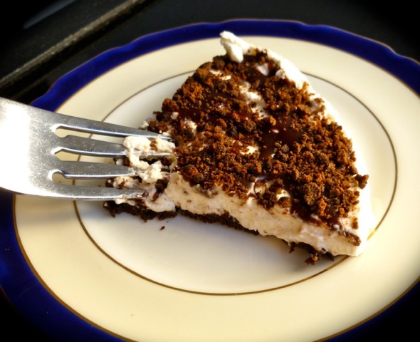 Slice of chocolate mint whipped cream pie on small plate with fork.