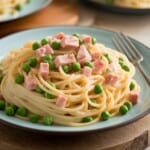 spaghetti tossed with diced ham and peas in a light cream sauce