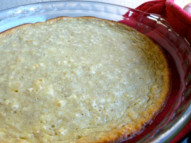 Banana Bread Pie in pie plate with red pot holder