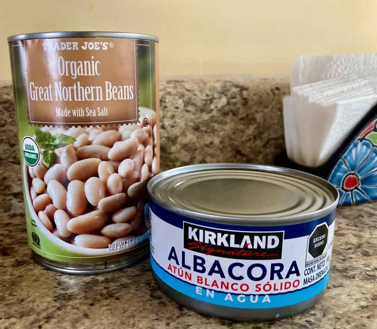 a can of great northern beans and can of albacore tuna on kitchen counter
