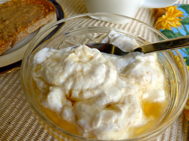 Skinny Banana Cream Pie Breakfast yogurt in glass bowl with spoon.