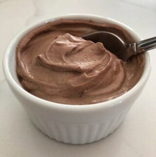creamy chocolate yogurt in white ramekin with spoon