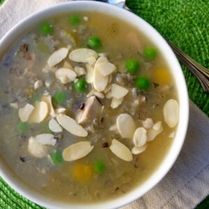 wild rice soup in a white bowl garnished with slivered almonds from above