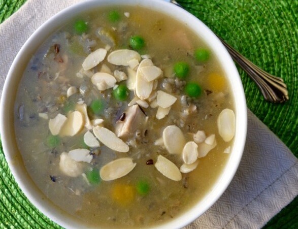 wild rice soup in a white bowl garnished with slivered almonds from above