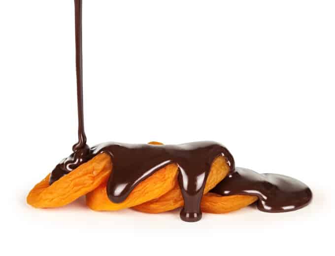 Dark chocolate drizzled on a dried apricots