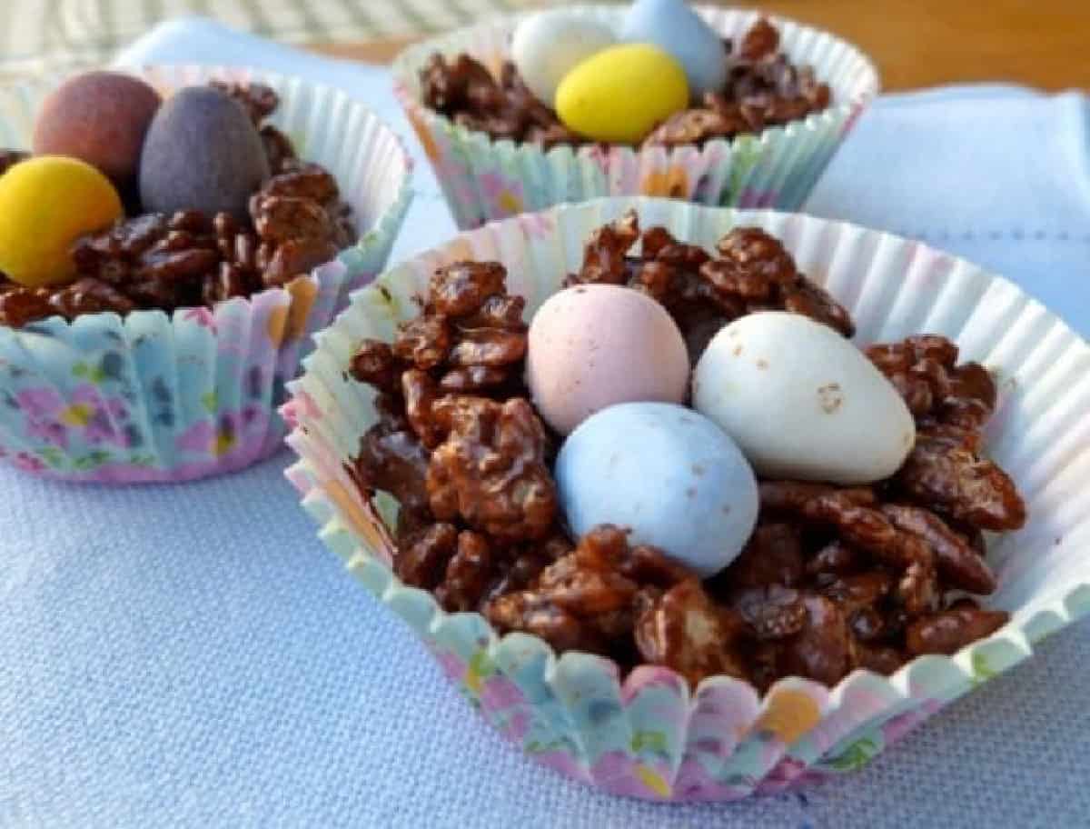 Chocolate Rice Krispie Easter Egg nests with Cadbury mini eggs in paper muffin cups.