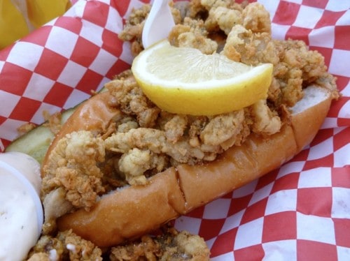 Fried Clam Roll in hot dog bun with lemon wedge.