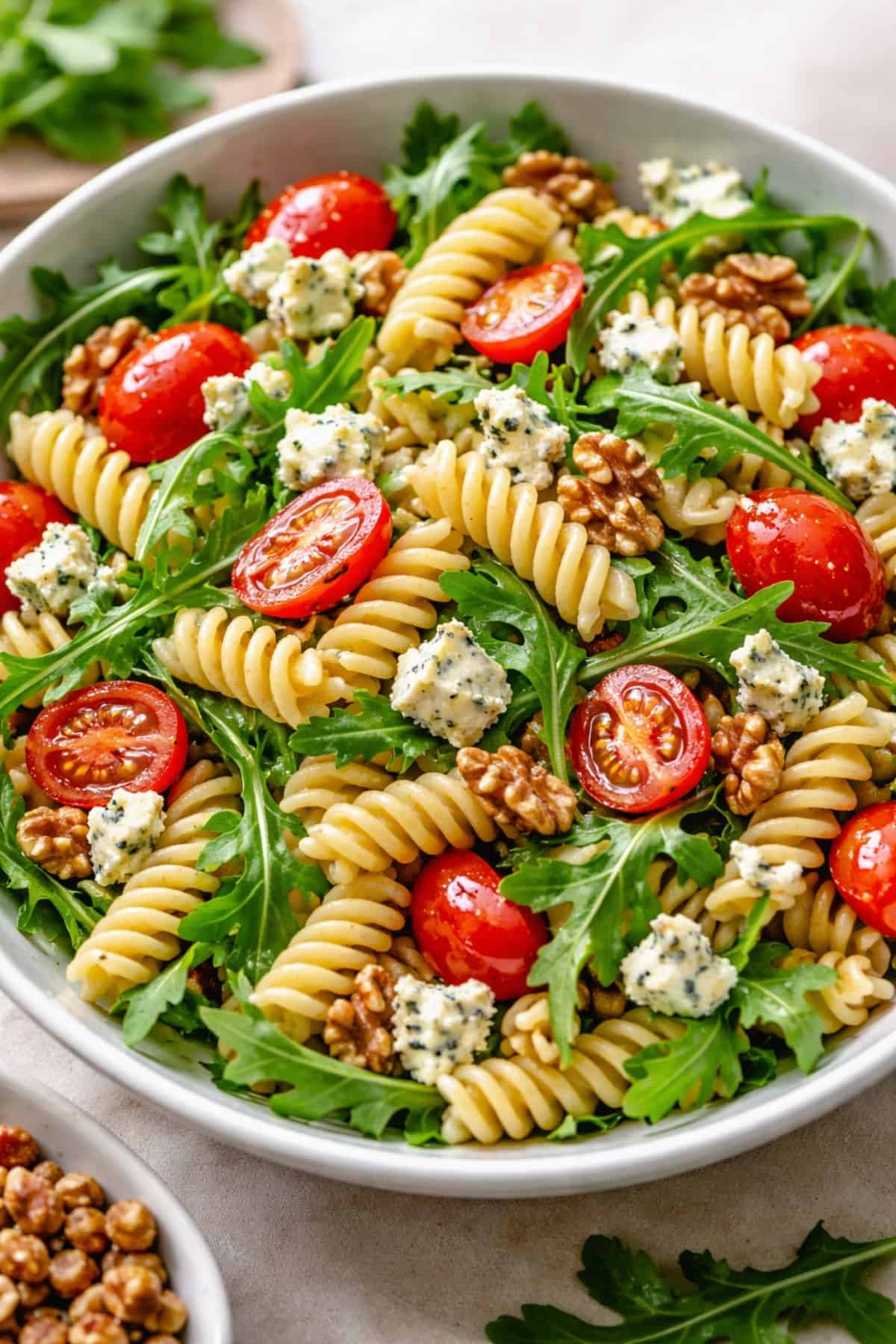 Pasta Salad with fusilli pasta, arugula, cherry tomatoes, walnuts and crumbled blue cheese.