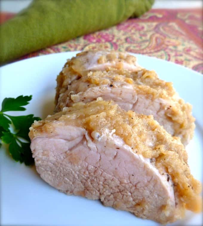 Roasted Pork with applesauce on a white serving plate