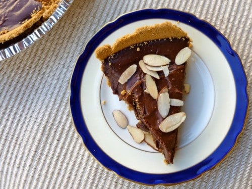 Piece of Chocolate Tart topped with sliced almonds.