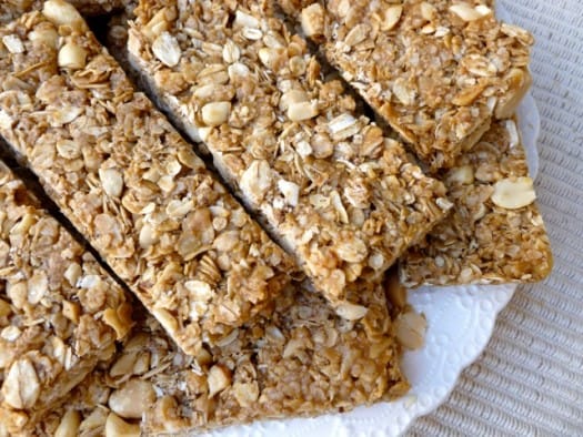 Crunchy Peanut Butter Granola Bars stacked on white plate.