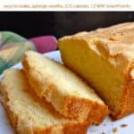 Homemade madeira cake slices with whole cake on white serving plate.