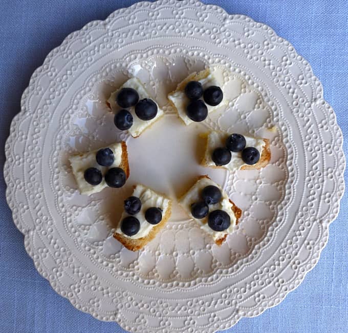Lemon blueberry trifle cake pieces arranged in circle on white plate.