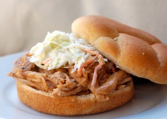 Slow Cooker Pulled Pork Loin Sandwich topped with cole slaw.