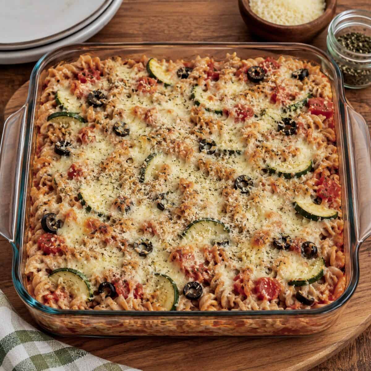 Baked pasta with zucchini and cottage cheese in a glass baking dish.